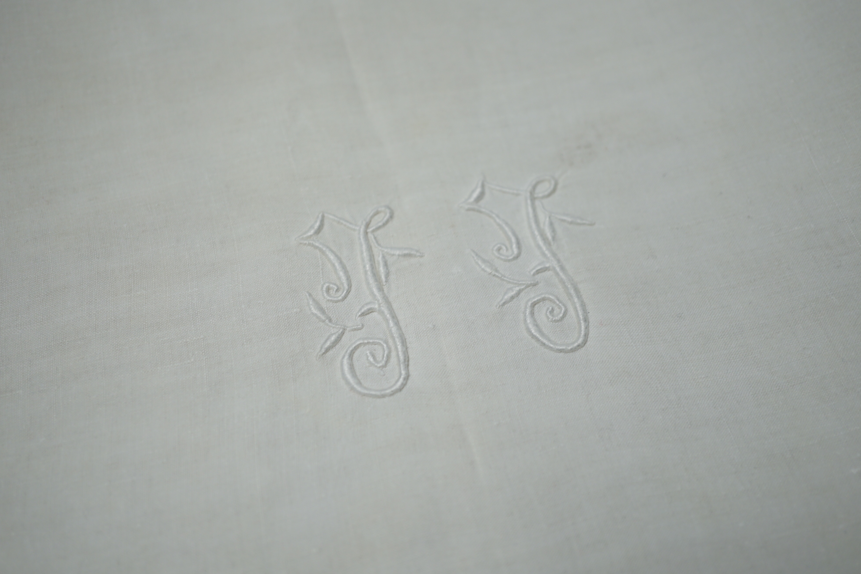 A French monogrammed linen refectory tablecloth and twelve matching dinner size napkins